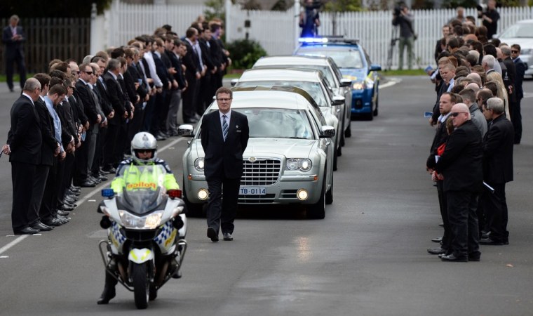 Mourners line the street outside St Therese's parish church in Melbourne for the funeral of baseball player Christopher Lane on Wednesday.