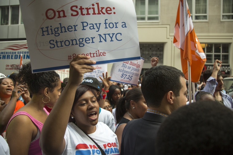 Zenquetta Charles (with sign) of Brooklyn, protests outside the Burger King in New York City's financial district where she works as a cashier for $7....