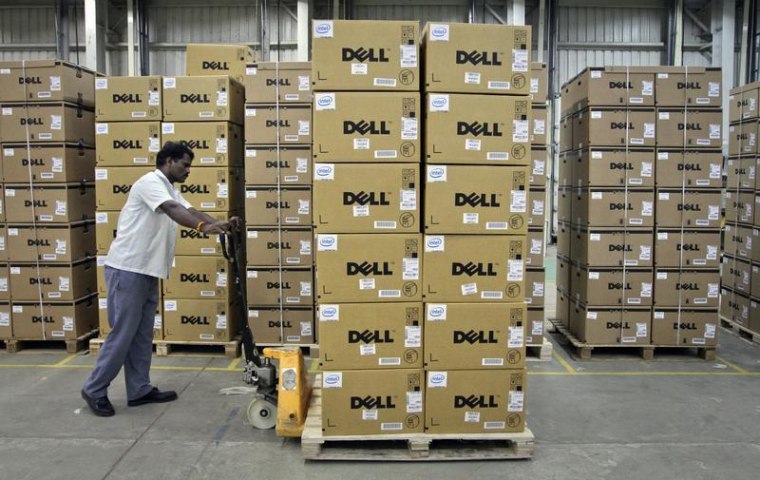 A man pushes a trolley full of Dell computers through a company factory in Sriperumbudur Taluk, in the Kancheepuram district of the southern Indian st...