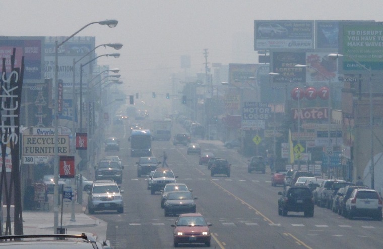 A smoky haze from a huge California wildfire burning more than 150 miles away hangs over Virginia Street in Reno, Nev.