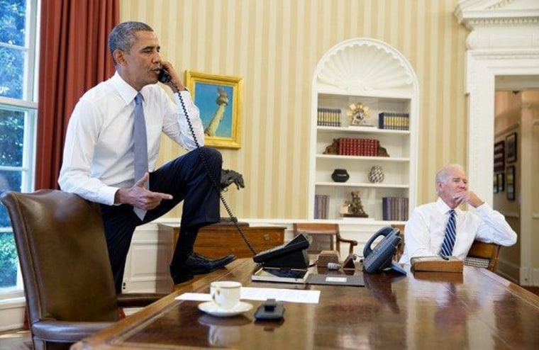 President Obama talks on the phone in the Oval Office with House Speaker Boehner earlier today.