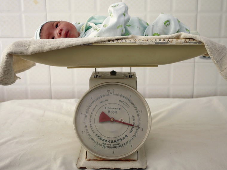 A newborn baby lies on a scale at a hospital in Suining, southwest China's Sichuan province, in this file photo.
