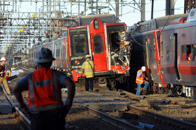 Emergency personnel work at the scene where two Metro North commuter trains collided, Friday, May 17, 2013 near Fairfield, Conn.