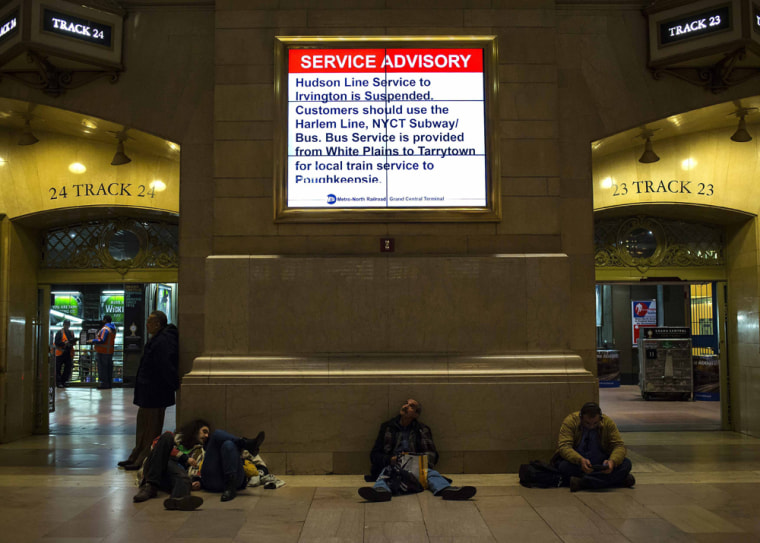 People wait at Grand Central Station following a Metro-North train derailment in the Bronx borough of New York on Sunday.