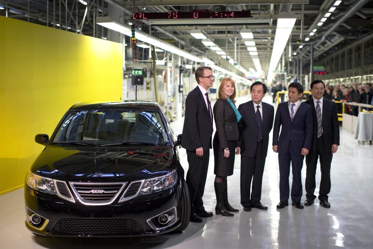 From left to right, NEVS MD Mattias Bergman, Swedish Minister for Enterprise Annie Loof, Chinese Ambassador Chen Yuming, vice mayor of Qingdao Li Chenggang and State Power Group CEO Kai Johan Jiang stand next to a first production NEVS Saab 9-3 Aero at the Trollhattan factory in Sweden on Dec. 2. The new owners of Swedish car maker Saab, National Electric Vehicle Sweden AB, restarted production of the 9-3 sedan Monday.