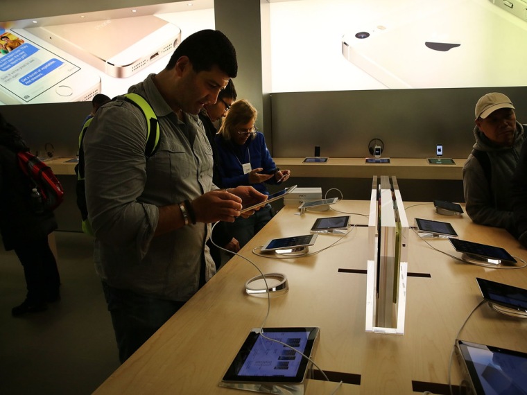 NEW YORK, NY - NOVEMBER 01: People try the new Apple iPad Air at the Apple Store on November 1, 2013 in New York City. The new iPad, the fifth generat...