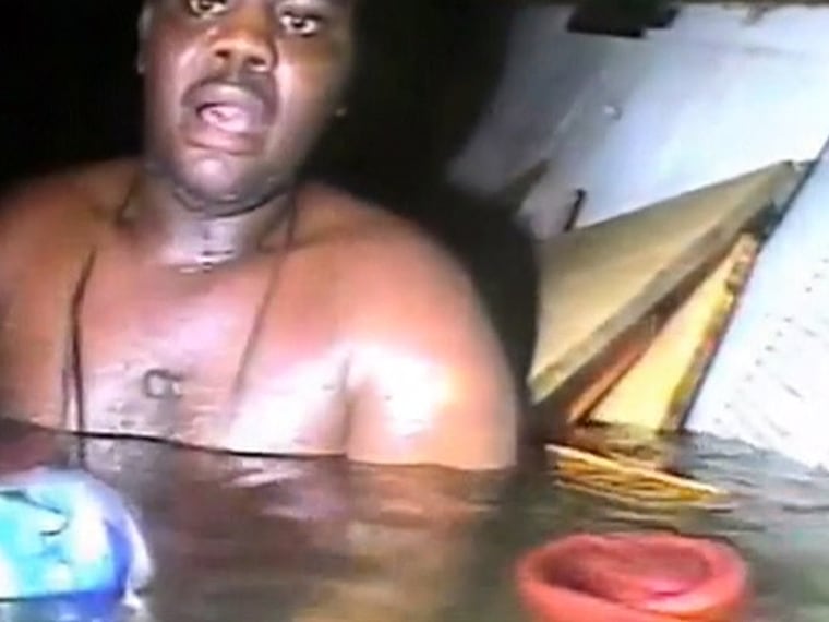 The head lamp of the rescue diver illuminates Okene, who survived on sips of Coca-Cola in only his underwear in the freezing cold water after the ship he worked on capsized in the Atlantic Ocean off the coast of Nigeria.