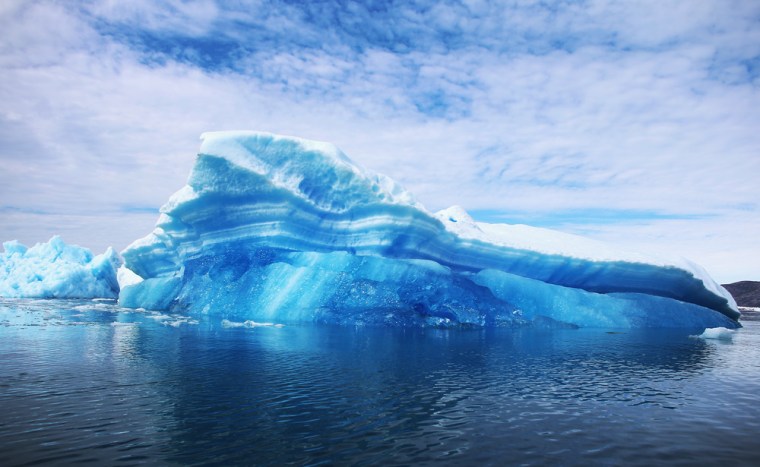 IMAGE: Calved icebergs from the nearby Twin Glaciers are seen floating on the water in Qaqortoq, Greenland.