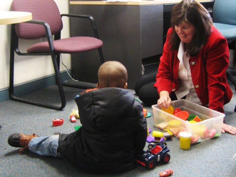 Denise Qualey, managing director at Kids in Crisis, and a former resident play with gifts from the TODAY Show Toy Drive