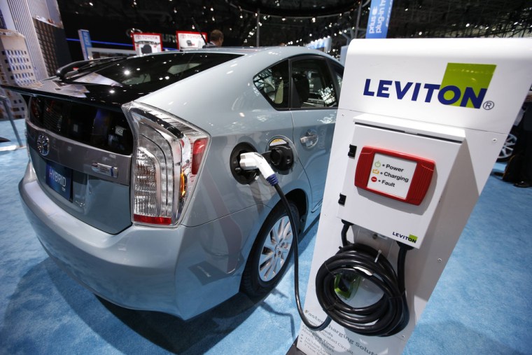 A 2013 Toyota Prius plug-in Hybrid car is seen plugged into a Leviton charging station at the Toyota display during a media preview at the 2013 New Yo...