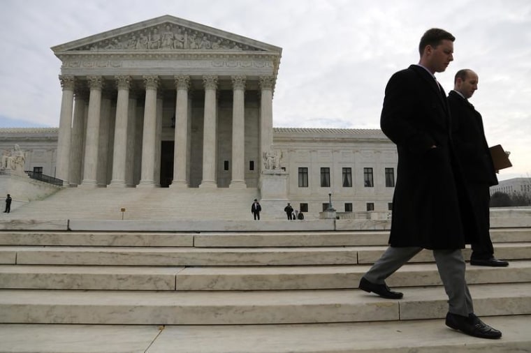 IMAGE: People walk outside the U.S. Supreme Court