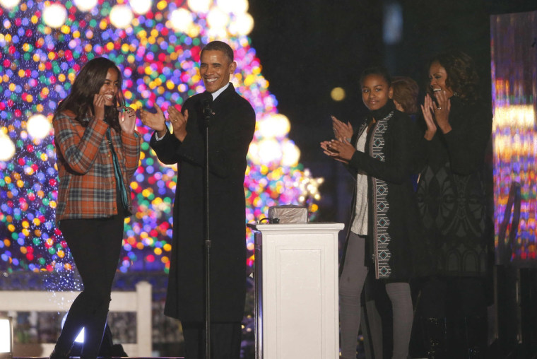 President Barack Obama, first lady Michelle Obama, daughters Sasha and Malia, applaud after lightng the National Christmas Tree at a ceremony across f...