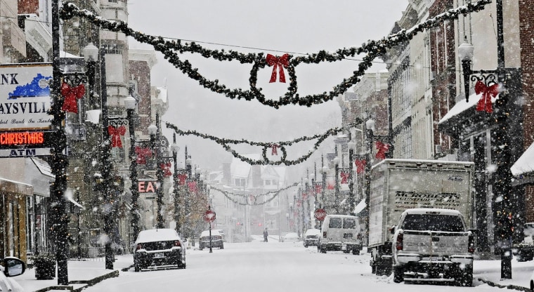 Snow falls in the downtown area of Maysville, Ky. Sunday, Dec. 8, 2013. A powerful storm system that spread hazardous snow, sleet and freezing rain widely across the nation's midsection rumbled toward the densely populated Eastern seaboard on Sunday, promising more of the same.