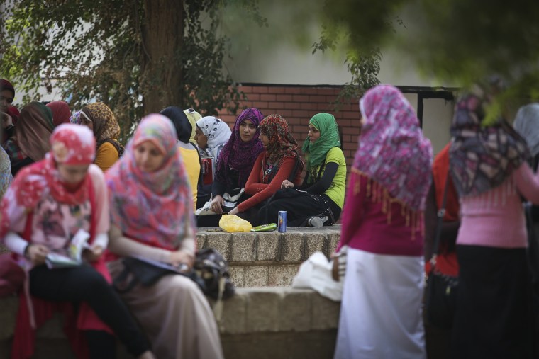 Egyptian women gather outside a university in Assiut, Egypt. Many young people are concerned about their marriage prospects in the new post-revolution Egypt.