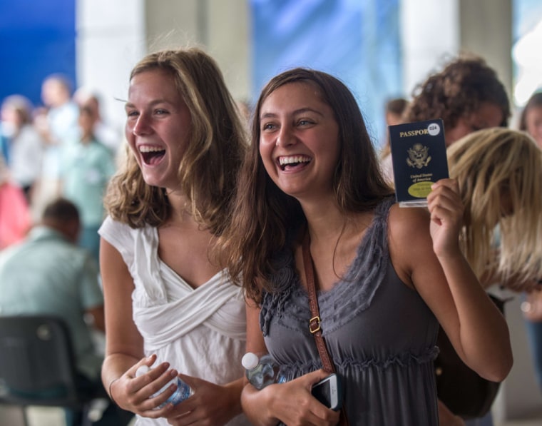 University students show their U.S. passports at the cruise ship terminal in Havana's harbor upon arrival.