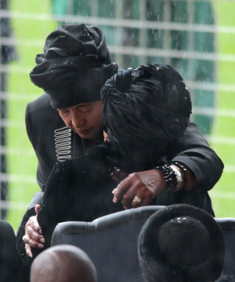 Winnie Mandela (left) and Graca Machel embrace as they arrive for Tuesday's memorial service.