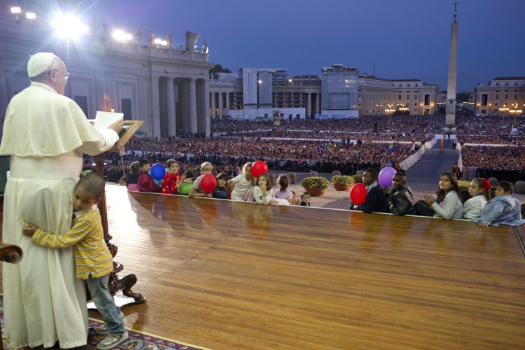 In this Saturday, Oct. 26, 2013 photo provided by the Vatican newspaper L'Osservatore Romano, a young boy, no name available, hugs Pope Francis as he ...