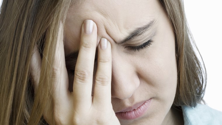Young woman hand on forehead, eyes closed, close-up depressed headache getty images stock, stress,