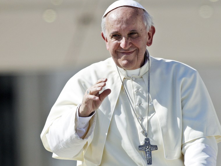 Pope Francis delivers his blessing as he is driven away on his pope-mobile at the end of his weekly general audience, in St. Peter's Square, at the Va...