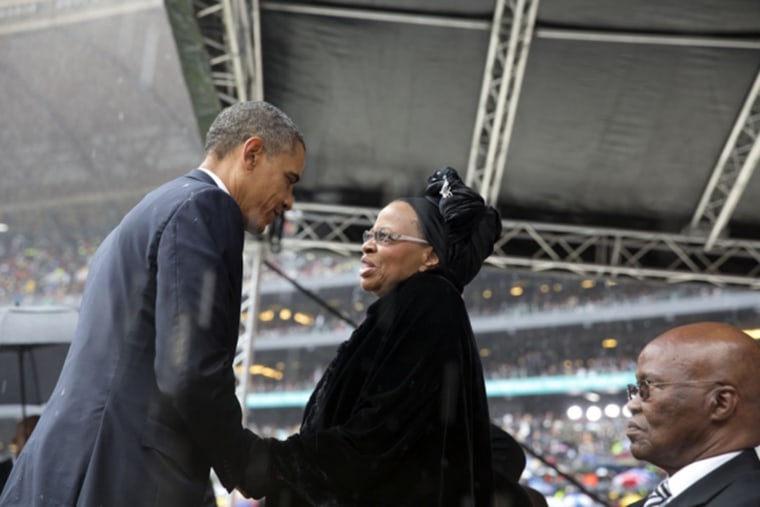 President Obama greets Graca Machel, Nelson Mandela's widow, after his speech at the memorial service