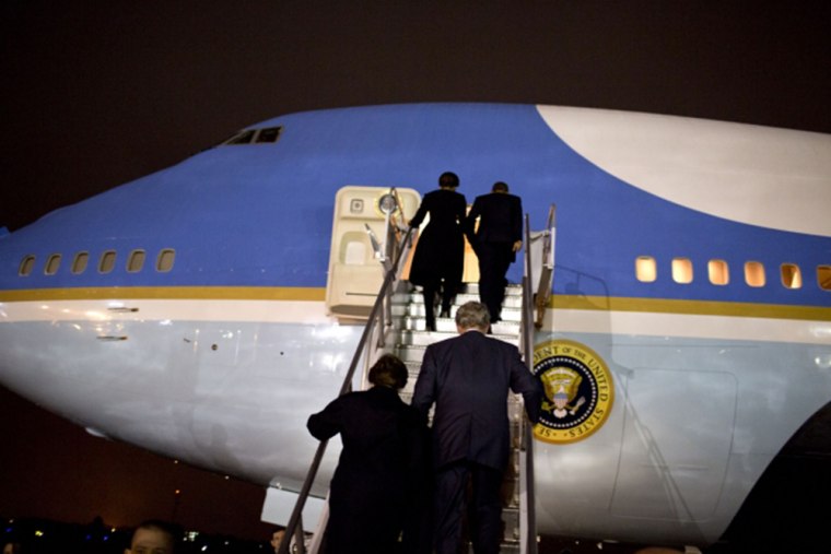 Laura and George W. Bush and Michelle and Barack Obama board Air Force One in Johannesburg.