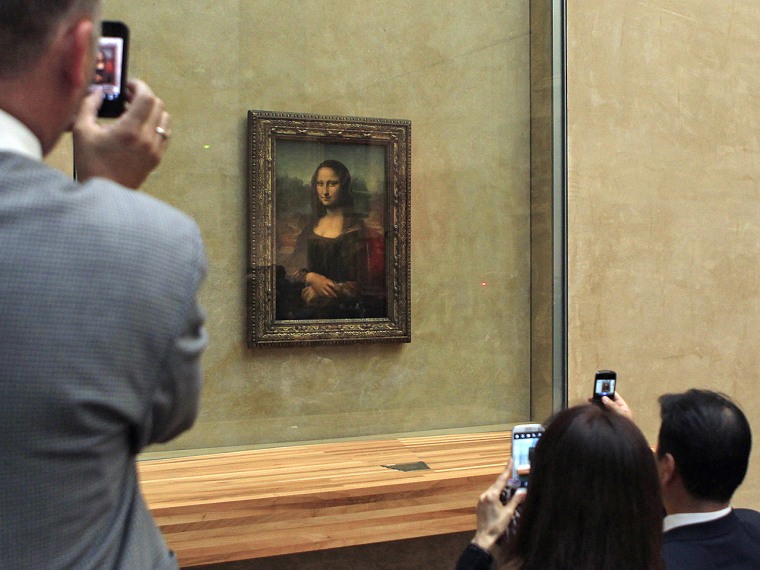 FILE: Guests take snapshots of Mona Lisa, during an event to unveil the new lighting of Leonardo da Vinci's painting Mona Lisa, also known as La Jocon...