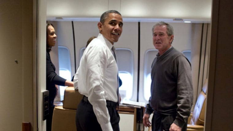 President Barack Obama jokes with former President George W. Bush shortly after boarding Air Force One for the trip to South Africa, Dec. 9, 2013.