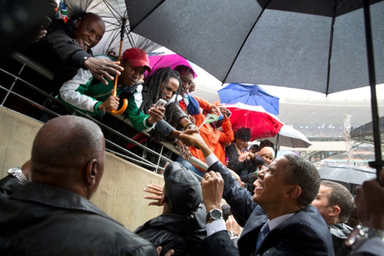 President Obama greets South Africans as he exits the field of the soccer stadium.