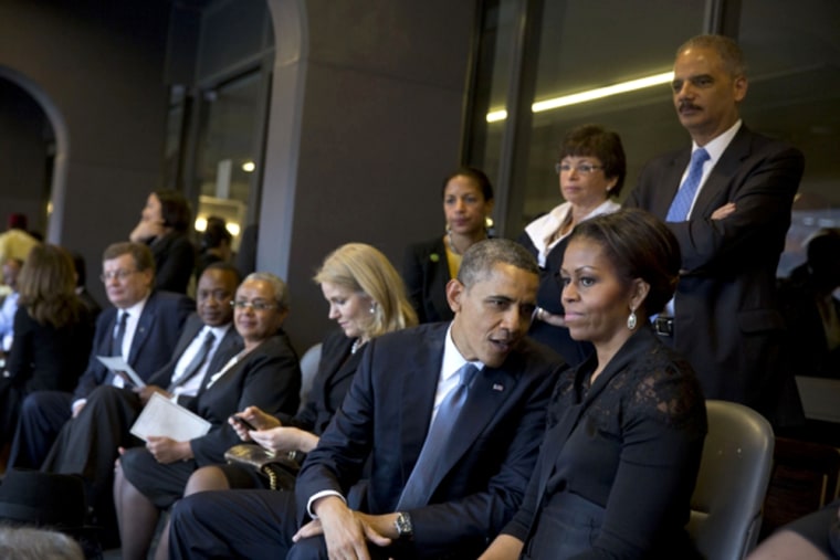 President Obama talks with the First Lady with other world leaders seated nearby. In the background are National Security Advisor Susan E. Rice, Valer...