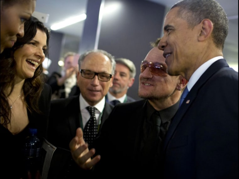 Bono greets President and Mrs. Obama as they get ready to depart the memorial service.