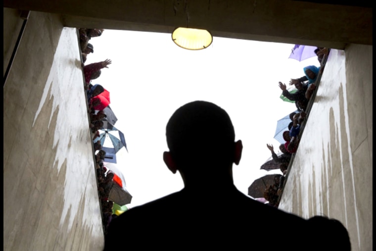 South Africans cheer as President Obama waits in a tunnel at the soccer stadium before taking the stage to speak at Nelson Mandela's memorial service.