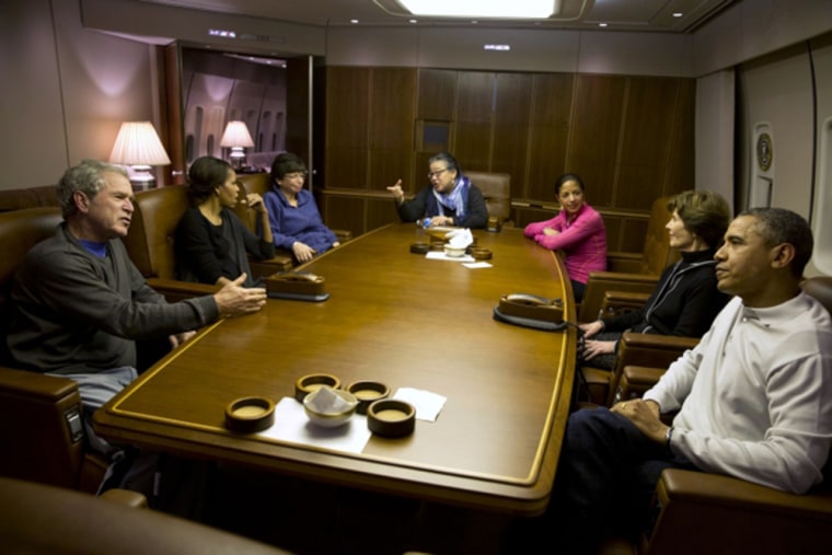 President Obama and President Bush talk as they get ready to have dinner aboard Air Force One with their wives and Valerie Jarrett, Tina Tchen and Sus...