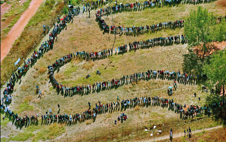 1994: A long line of people waits outside the polling station in the black township of Soweto, in the southwest suburbs of Johannesburg, to vote in South Africa's first all-race elections on April 27, 1994. Mandela was elected by Parliament as the first president of a democratic South Africa on May 9, 1994.