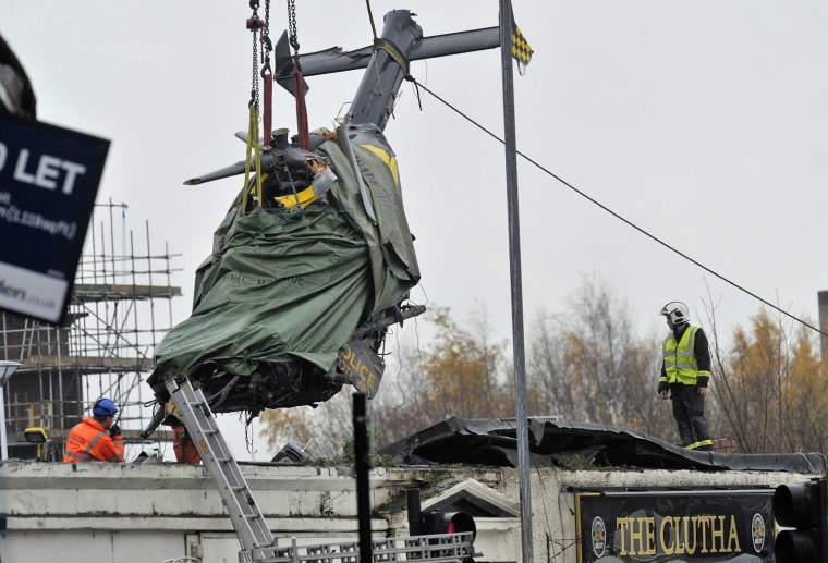 The wreckage of a police helicopter is winched from the collapsed roof of a pub in Glasgow on Dec. 2.