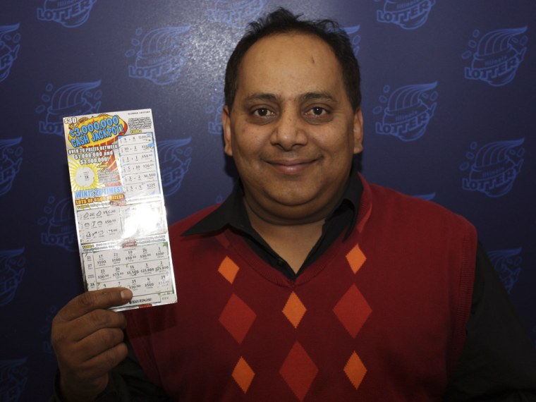 Urooj Khan of Chicago is pictured holding his winning $1 million lottery ticket in this undated handout photo from the Illinois Lottery. Khan died of cyanide poisoning on July 20, 2012, and his death is now a homicide investigation.