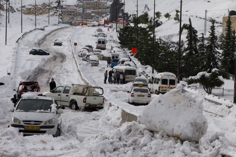 Vehicles are seen stranded in snow in Jerusalem on Dec. 13. The hilltop city of Jerusalem was paralyzed by its fiercest snowstorm in years, with its mayor calling out the army to help stranded motorists.