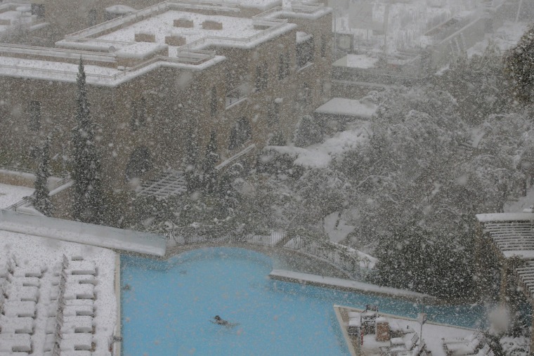 A woman swims in the pool at the David Citadel Hotel during a snowstorm in Jerusalem on Dec. 13.