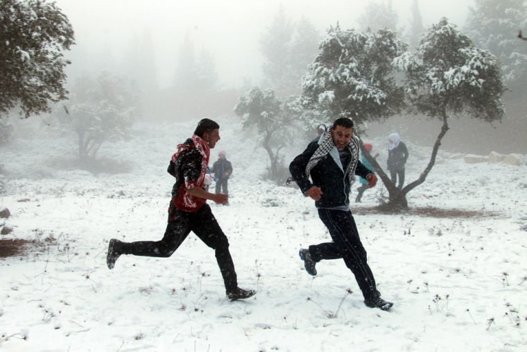 Palestinians enjoy a snowball fight during snowy weather in the West Bank city of Nablus on Dec. 12. The Palestinian Authority announced that schools would be closed due to adverse weather conditions.
