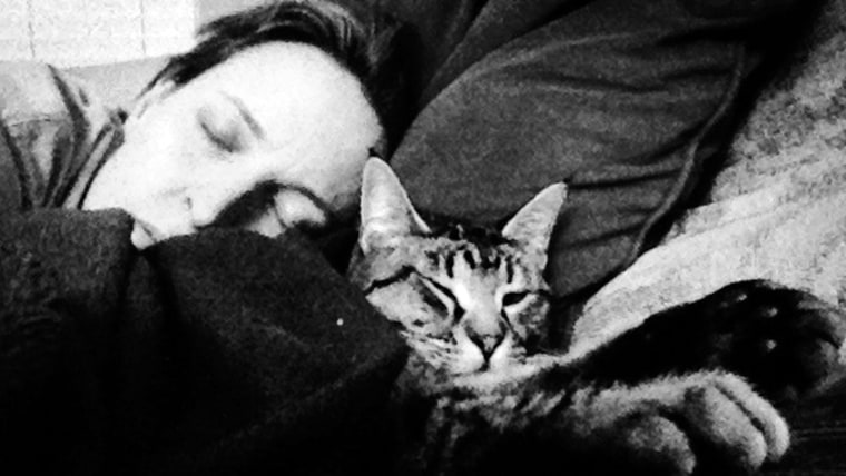 After his rescue, Linus the cat (pictured here with mom Debbie), slept for two days.