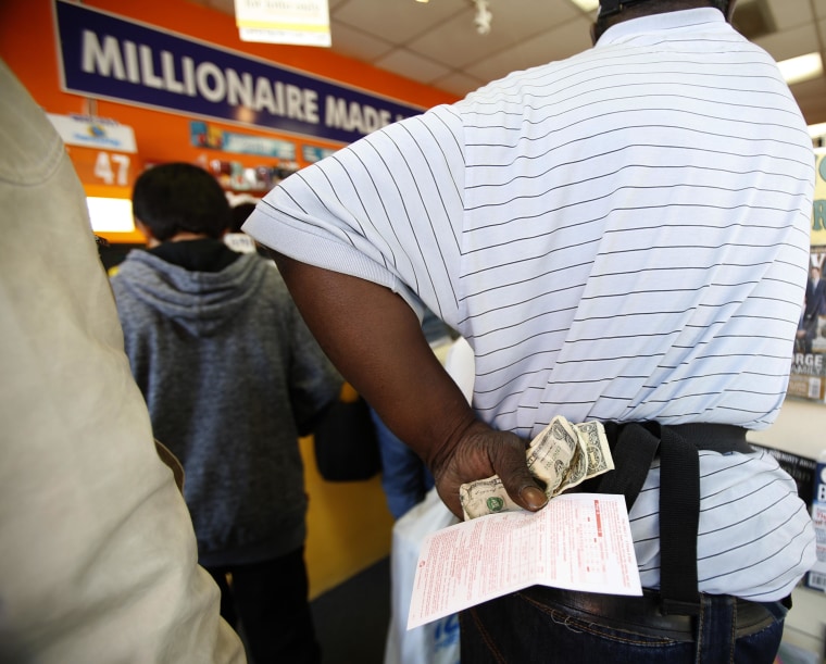 People wait in line to buy lottery tickets at a newsstand in Los Angeles on Friday.