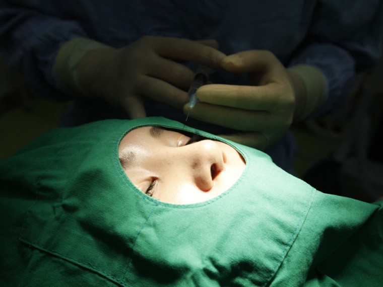 Plastic surgeon Park Yong-Joon treats a patient at the Wonjin cosmetic surgery in the Gangnam district of Seoul, on Oct. 2, 2012.
