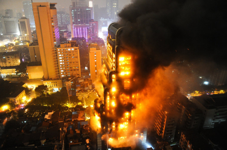 Smoke rises from a burning building in Guangzhou, China, on Dec. 15, 2013.