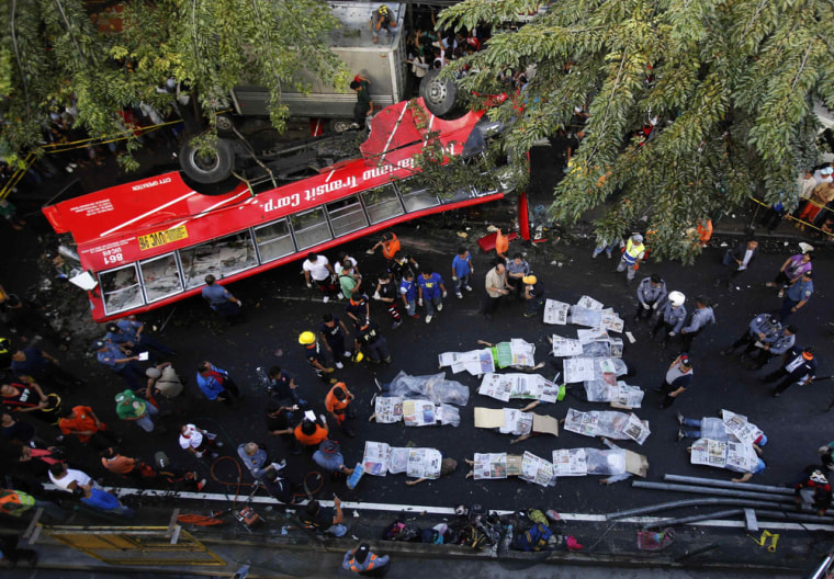 Bodies of passengers lie beside a bus after it fell off an elevated expressway and crashed into a van in Taguig city, south of Manila, on Monday.