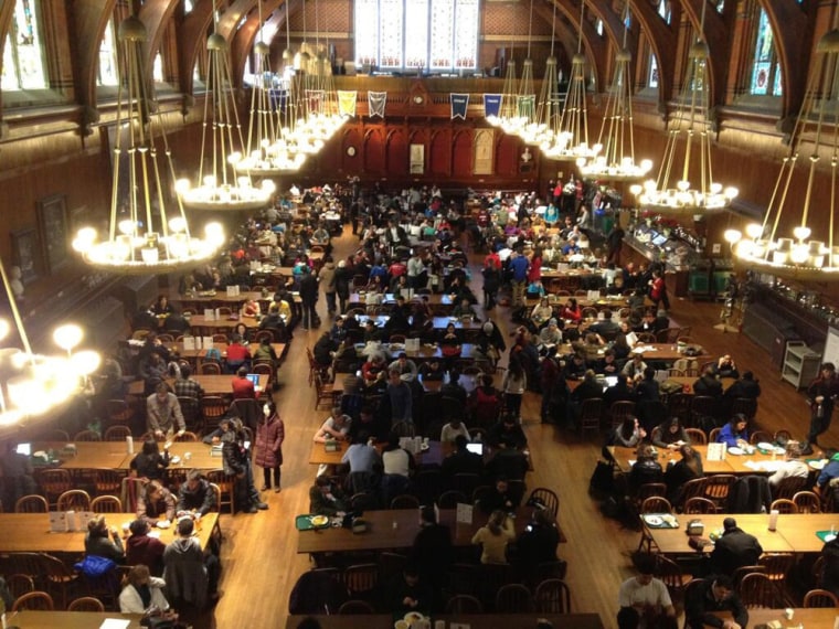 Harvard University students gather in Annenberg Hall after being evacuated from campus buildings.