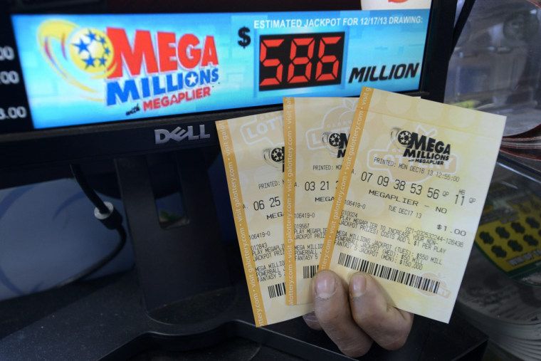 A salesman holds Mega Millions lottery tickets at a retailer in Decatur, Georgia, USA, 16 December 2013.