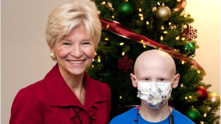 Owen Perry and Sandra Fenwick, president and CEO of Boston Children's Hospital, after Owen helped light a hospital Christmas tree.