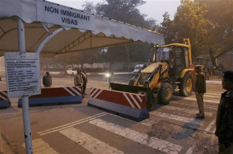 Indian police on Tuesday remove barricades that had been erected as a safety measure outside the main entrance of the U.S Embassy in New Delhi, reportedly in retaliation to the alleged mistreatment of New York-based Indian diplomat Devyani Khobragade.
