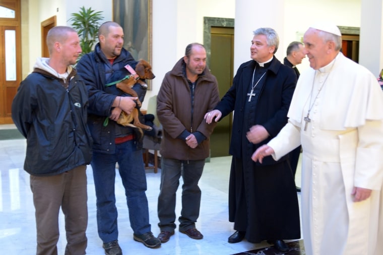 Pope Francis, right, prepares to meet homeless people as he celebrates his 77th birthday at the Vatican on Dec. 17.