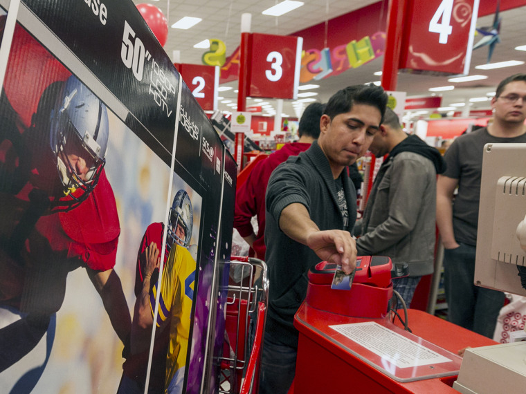 A customer swipes his credit card to pay for a television doorbuster deal at a Target store in Burbank, Calif., on Nov. 22, 2012.