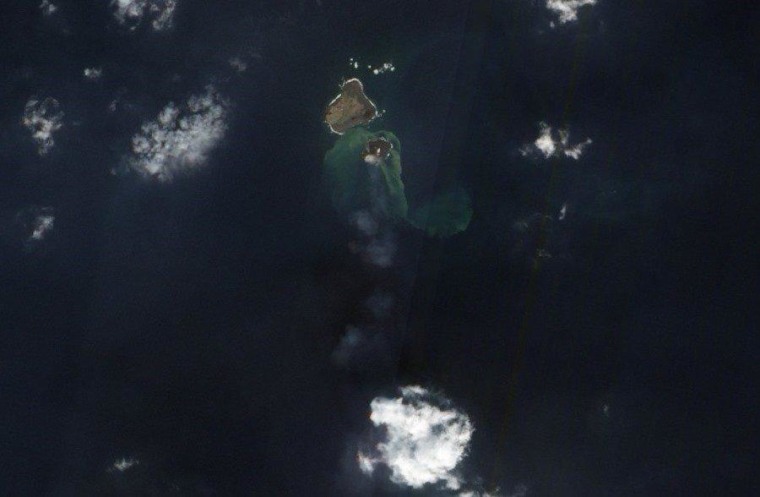 An imager on NASA's Earth Observing 1 satellite captured this Dec. 8 picture of the new volcanic island, Niijima, sitting next to another volcanic island called Nishino-shima. Stirred-up sediment lightens up the waters around Niijima, and the white puffs seen above the baby island and heading out to sea are thought to be clouds of steam and other volcanic gases.